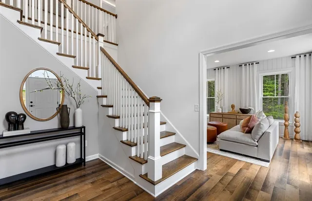 a view of entryway livingroom and hall with wooden floor