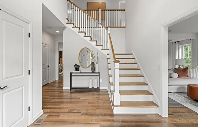 a view of entryway and hall with wooden floor