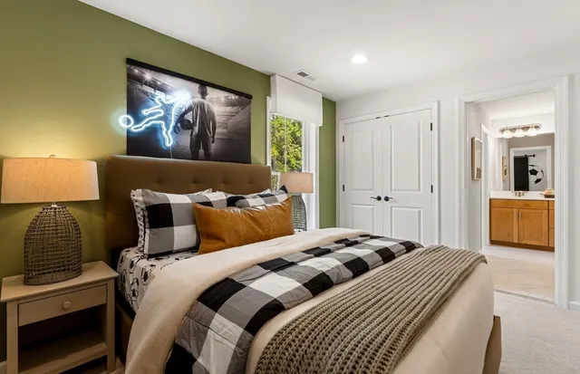 a bedroom with a bed and a lamp