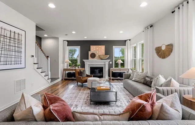 a living room with furniture and a fireplace