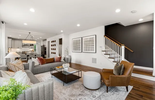 a living room with furniture and a wooden floor