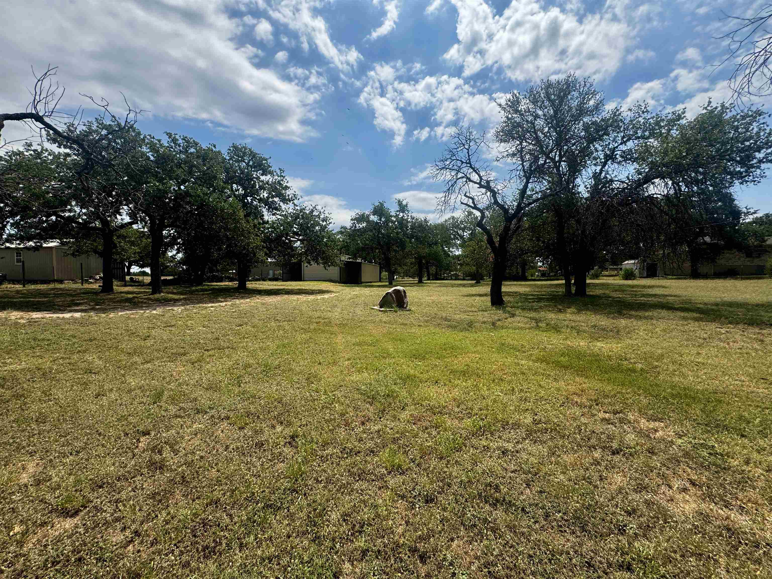 a view of tennis ground with trees in the background