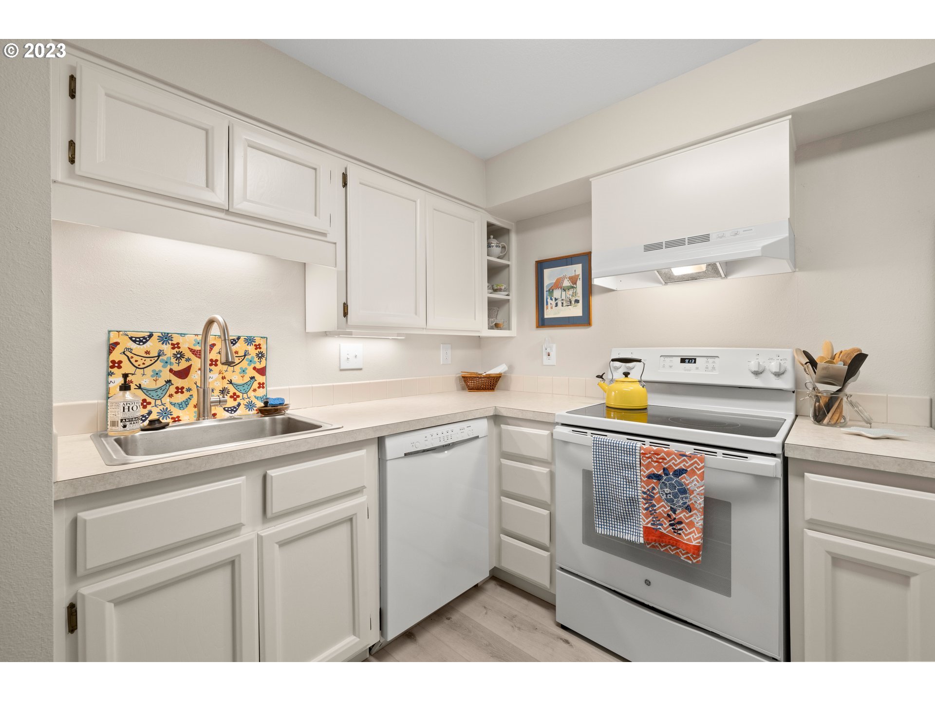 8720 Southwest Tualatin Road, Unit 321 Tualatin, OR 97062 - Photo 7 of 21 a kitchen with stainless steel appliances a sink a stove and white cabinets
