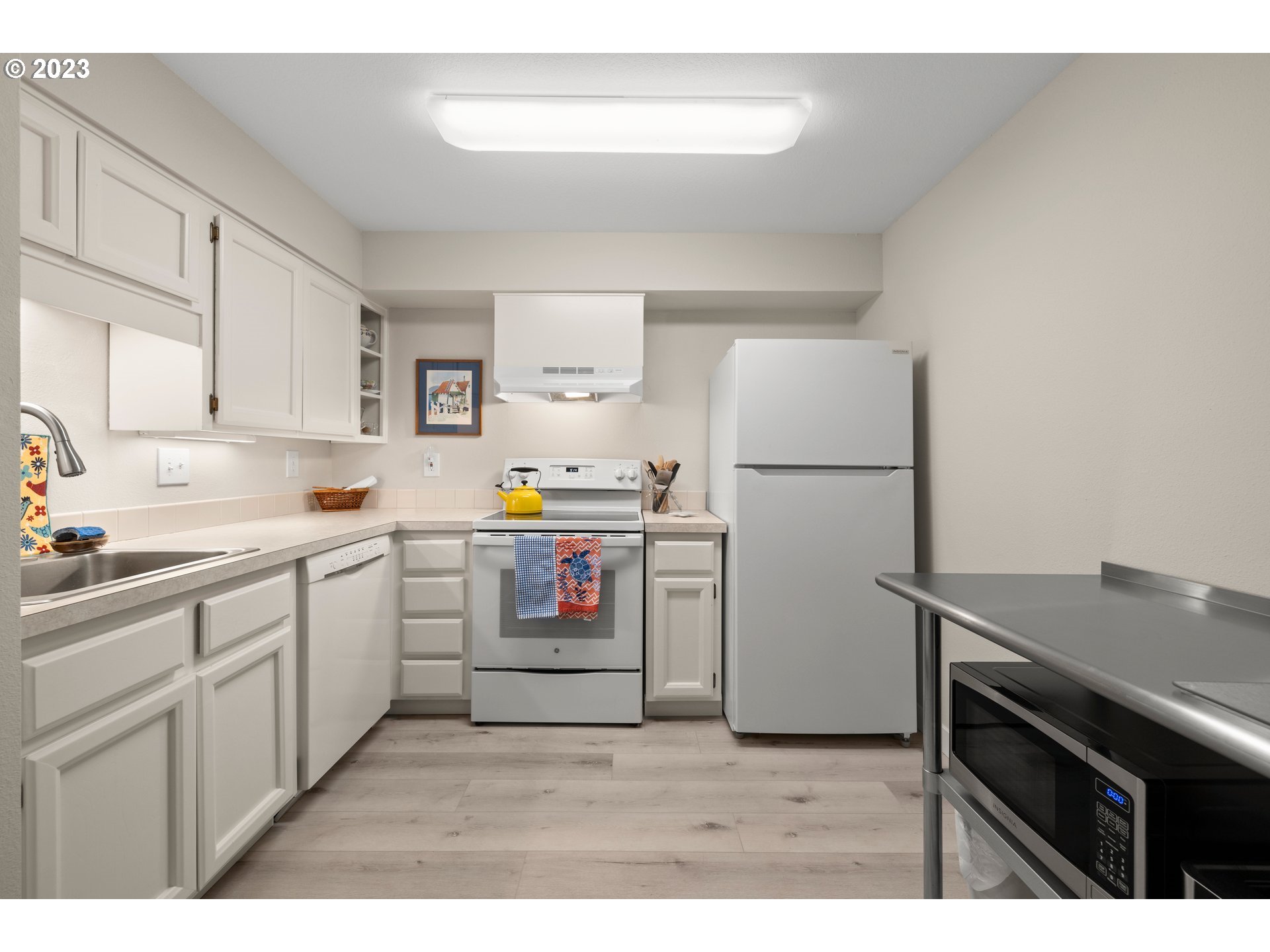 8720 Southwest Tualatin Road, Unit 321 Tualatin, OR 97062 - Photo 8 of 21 a kitchen with a refrigerator sink and cabinets