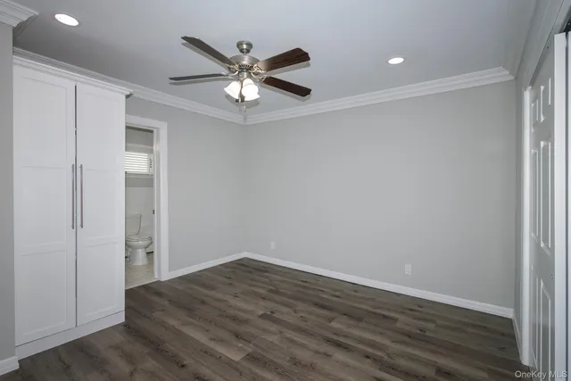 a view of a big room with wooden floor and closet area