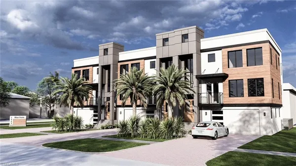 a front view of multiple houses with yard