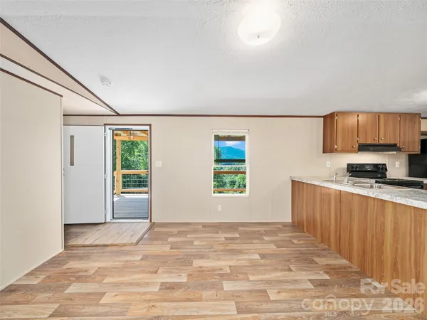 a kitchen with granite countertop a stove top oven and refrigerator