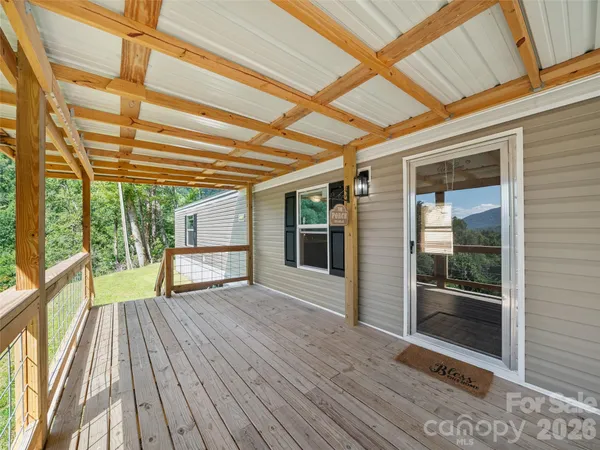 a view of wooden floor and a window in a room