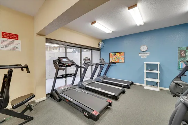 a room with gym equipment equipment and a window