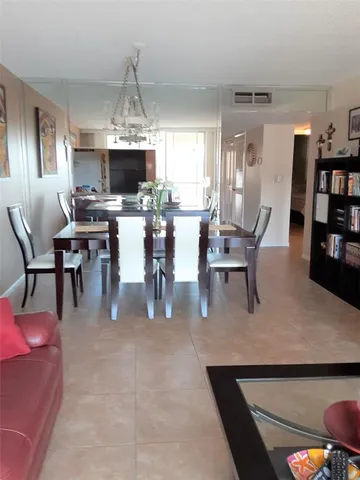 a dining room with furniture a rug and a chandelier