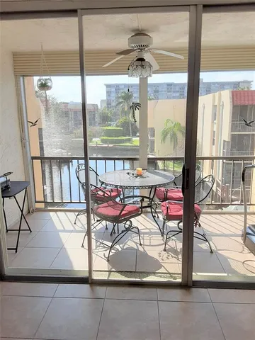 a living room with a glass door and glass door
