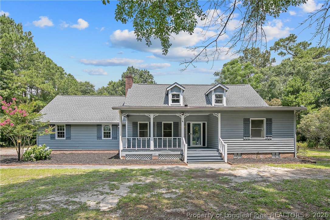 6062 Midus Street Hope Mills, NC 28348 - Photo 1 of 49 a front view of a house with a garden