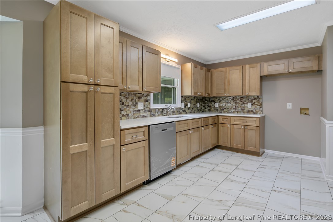 6062 Midus Street Hope Mills, NC 28348 - Photo 11 of 49 a kitchen with stainless steel appliances granite countertop a sink and cabinets