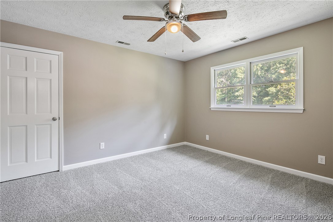 6062 Midus Street Hope Mills, NC 28348 - Photo 41 of 49 a view of an empty room with window and a chandelier fan