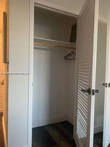 a bedroom with two beds and a desk