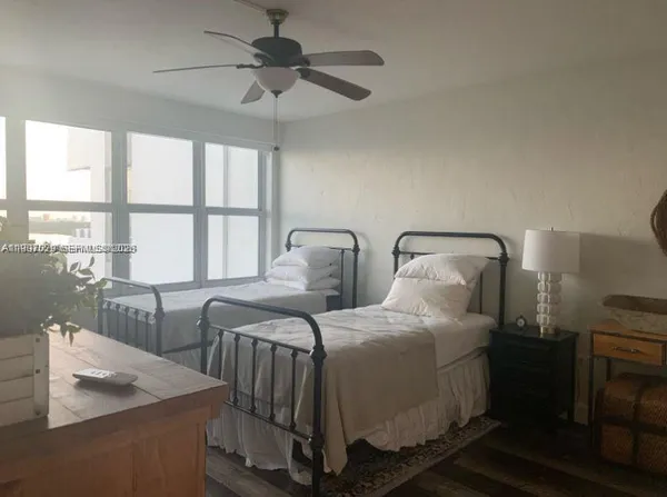 a bedroom with two beds and a chandelier