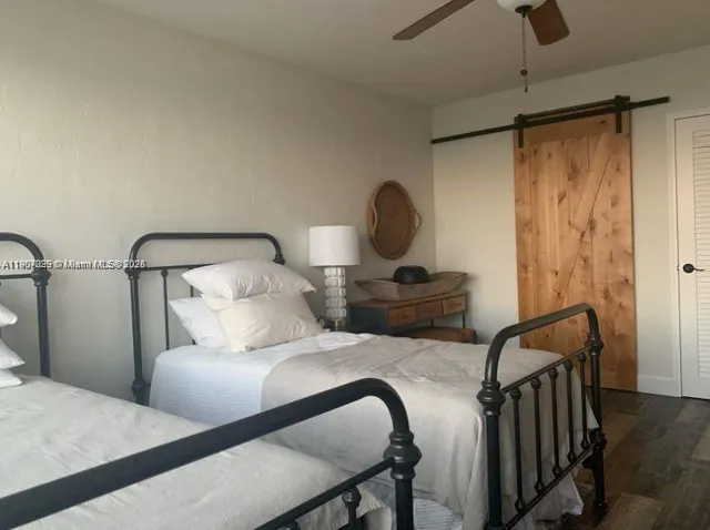 a bedroom with a bed and a lamp