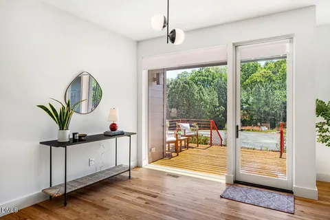 a view of a hallway with wooden floor and windows