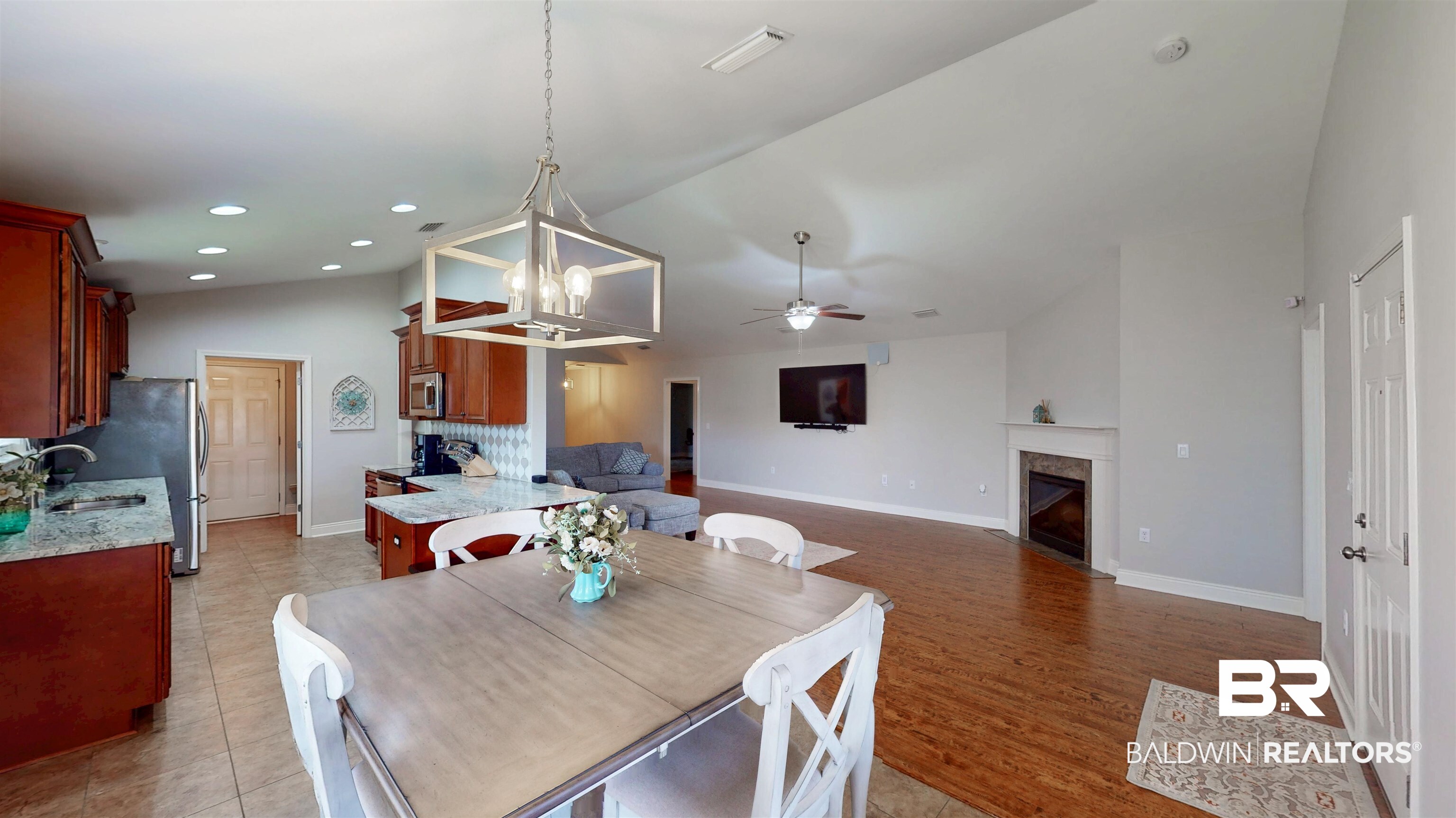 1704 Arcadia Drive Foley, AL 36535 - Photo 24 of 52 Dining area featuring a fireplace, a chandelier, ceiling fan, recessed lighting, and vaulted ceiling