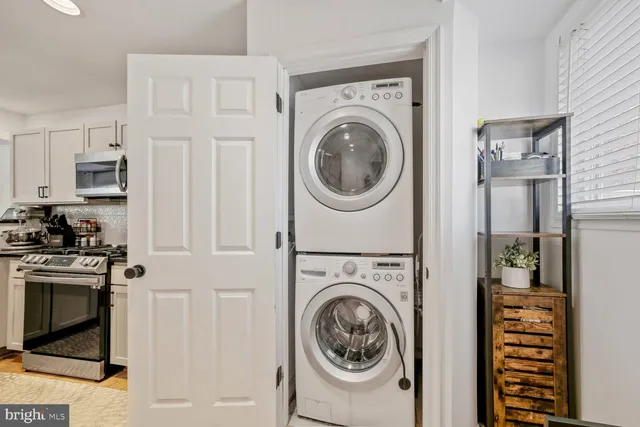 a view of a storage and utility room with washer and dryer