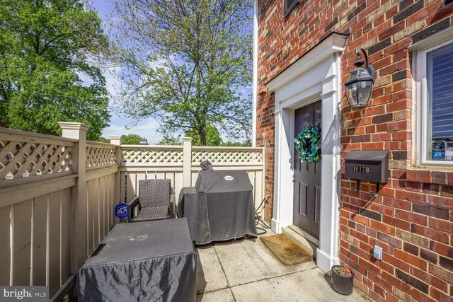 a view of a house with a sink and wooden fence
