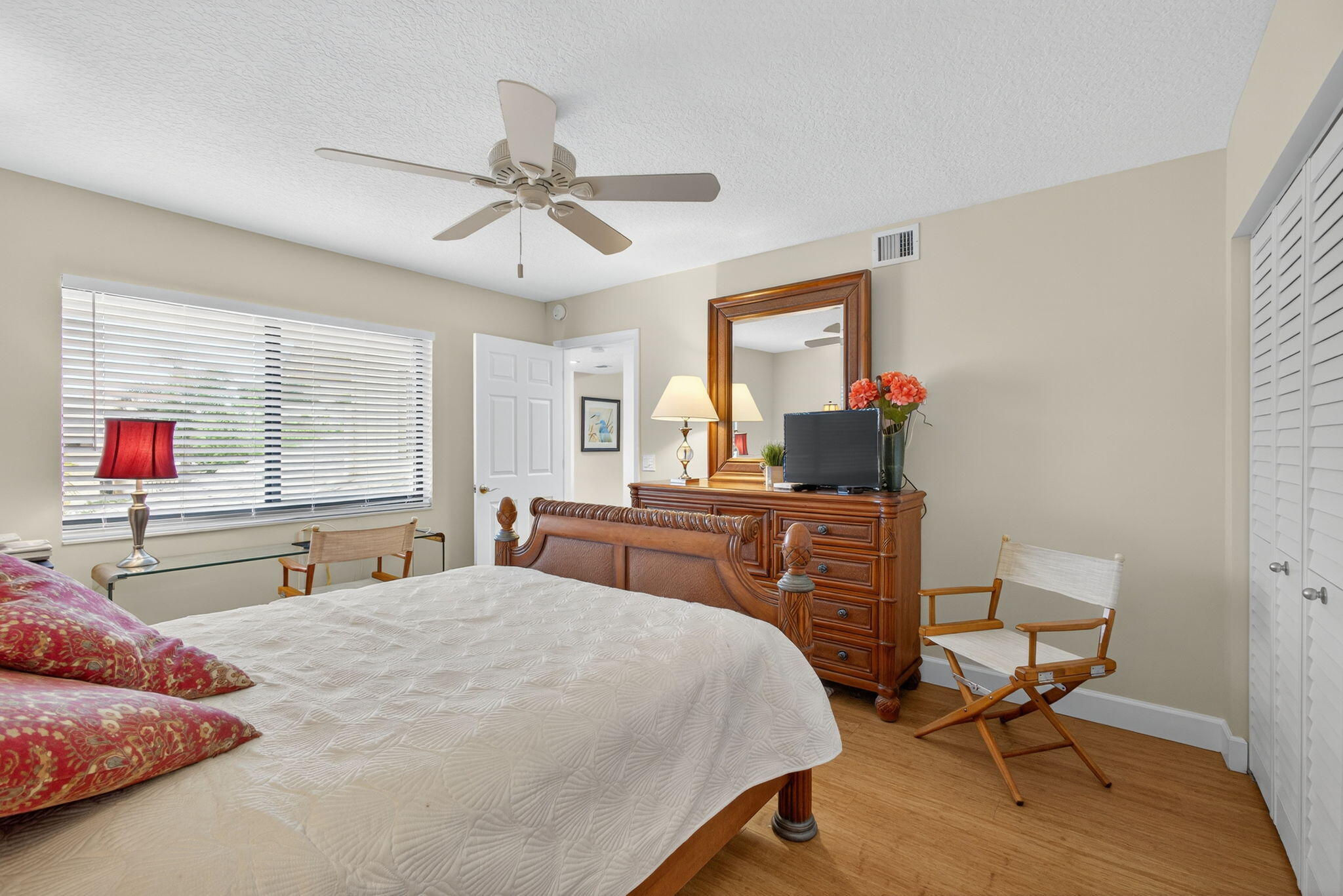 16941 Waterbend Drive, Unit 252 Jupiter, FL 33477 - Photo 21 of 34 a bedroom with a bed and wooden floor