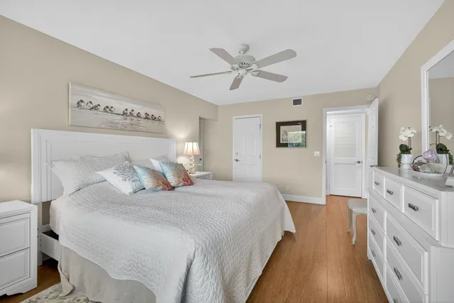 a spacious bedroom with a bed and a chandelier