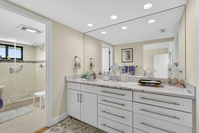 a bathroom with a granite countertop sink mirror and double