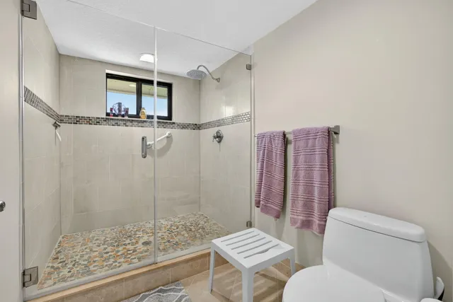 a bathroom with a toilet a sink and a shower