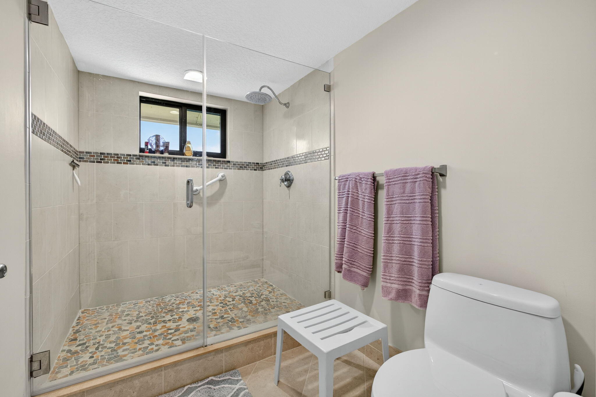 16941 Waterbend Drive, Unit 252 Jupiter, FL 33477 - Photo 28 of 34 a bathroom with a toilet a sink and a shower