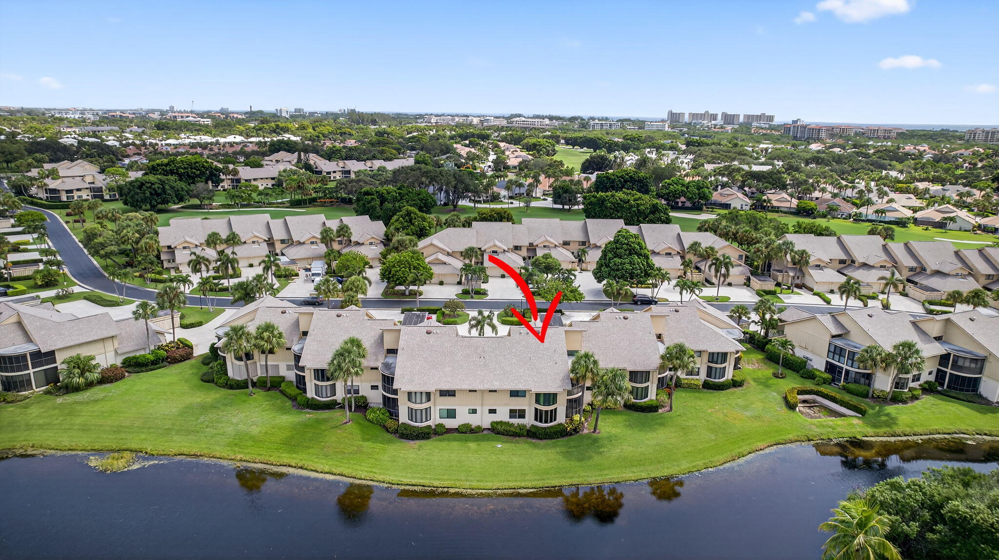 16941 Waterbend Drive, Unit 252 Jupiter, FL 33477 - Photo 31 of 34 an aerial view of a house with a garden and lake view