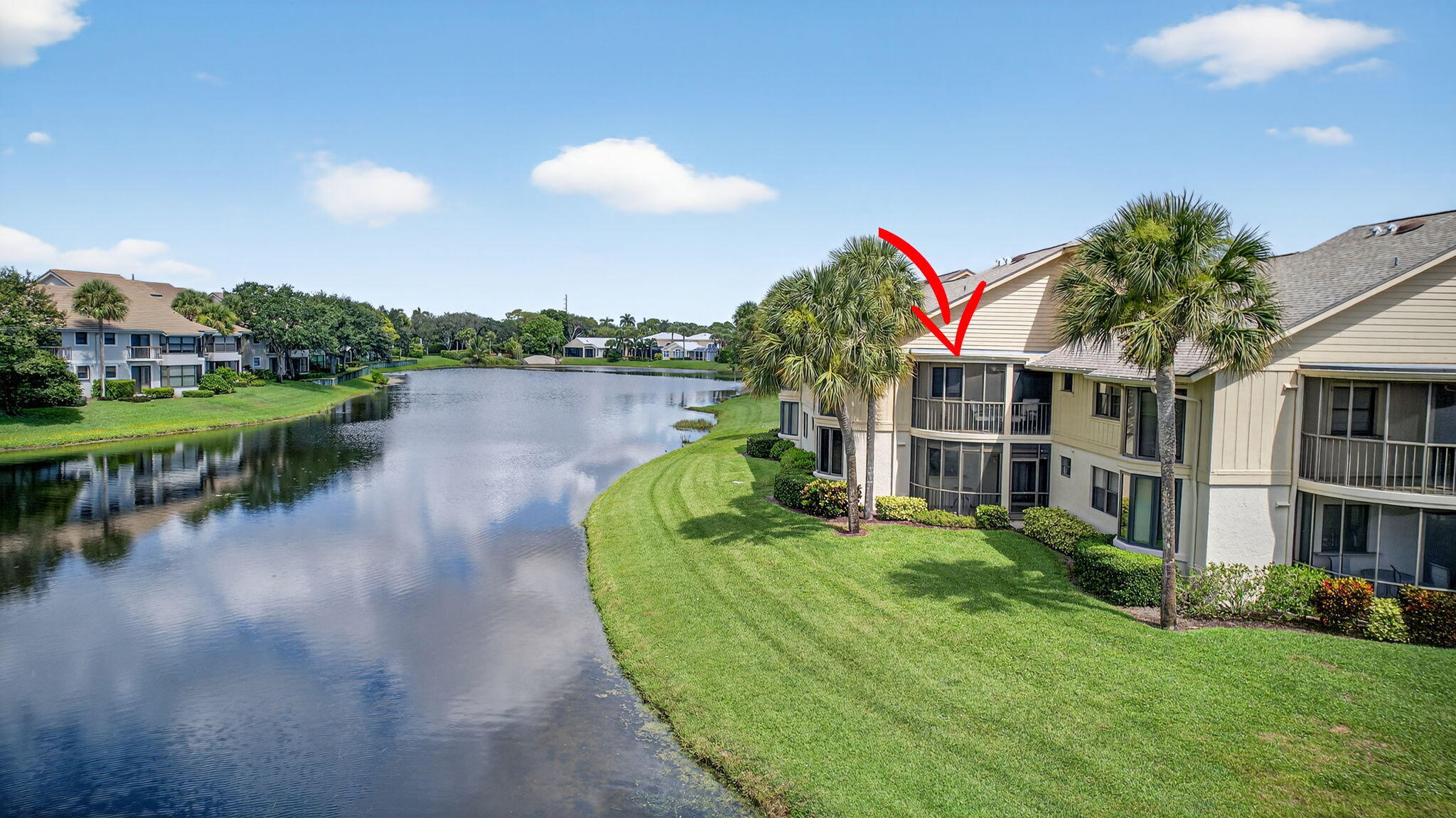 16941 Waterbend Drive, Unit 252 Jupiter, FL 33477 - Photo 33 of 34 a view of a house with a yard and sitting area