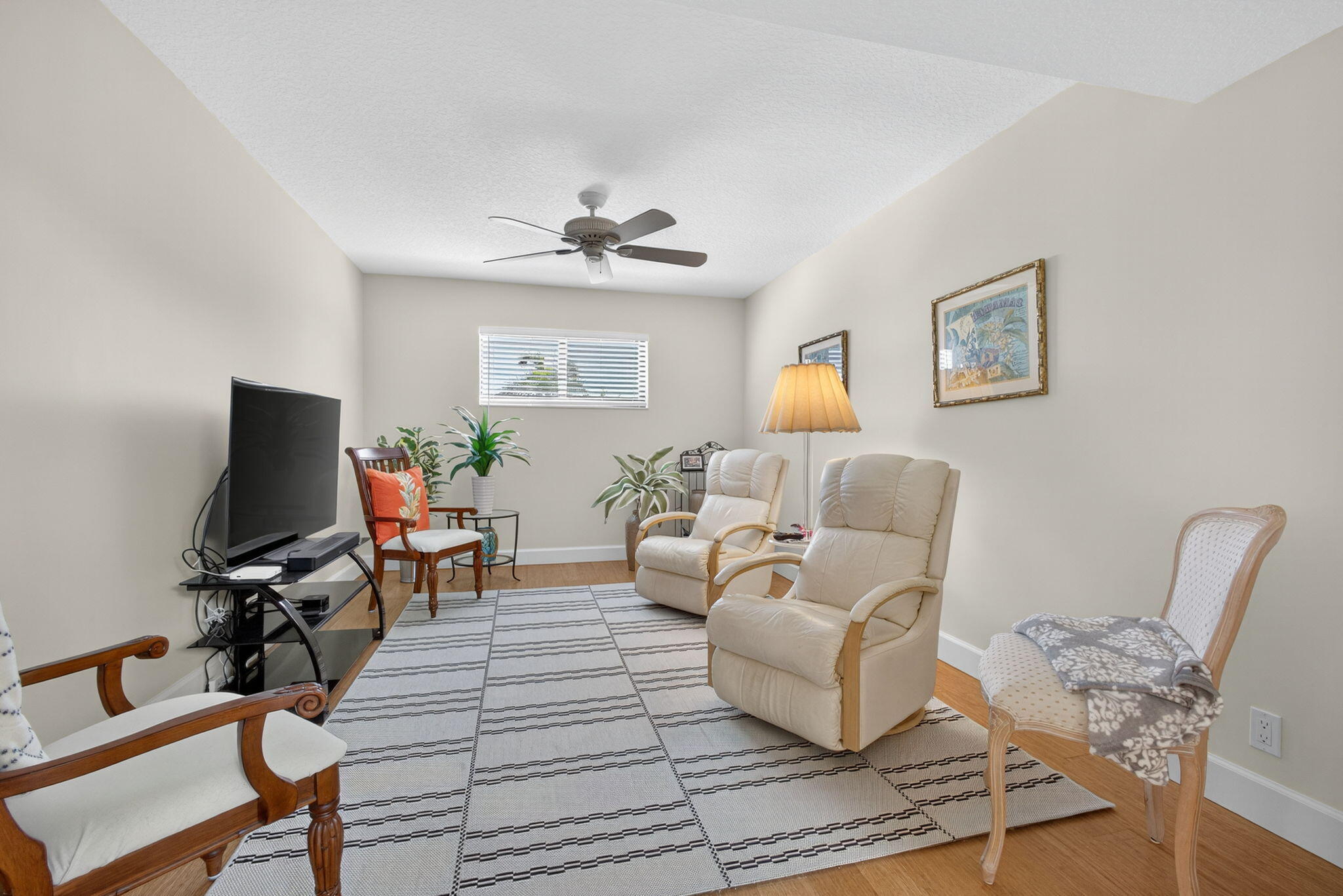 16941 Waterbend Drive, Unit 252 Jupiter, FL 33477 - Photo 9 of 34 a living room with furniture a flat screen tv and a window