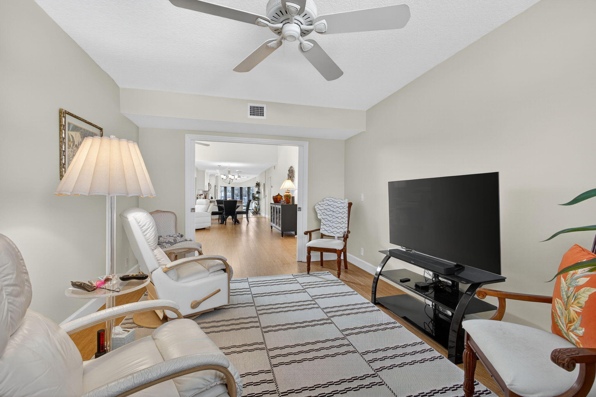 16941 Waterbend Drive, Unit 252 Jupiter, FL 33477 - Photo 10 of 34 a living room with furniture and a flat screen tv