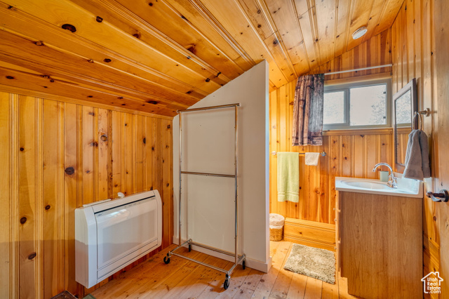 714 Spotted Fawn Way Kamas, UT 84036 - Photo 20 of 34 Washroom with wood-type flooring, wooden walls, wooden ceiling, and heating unit