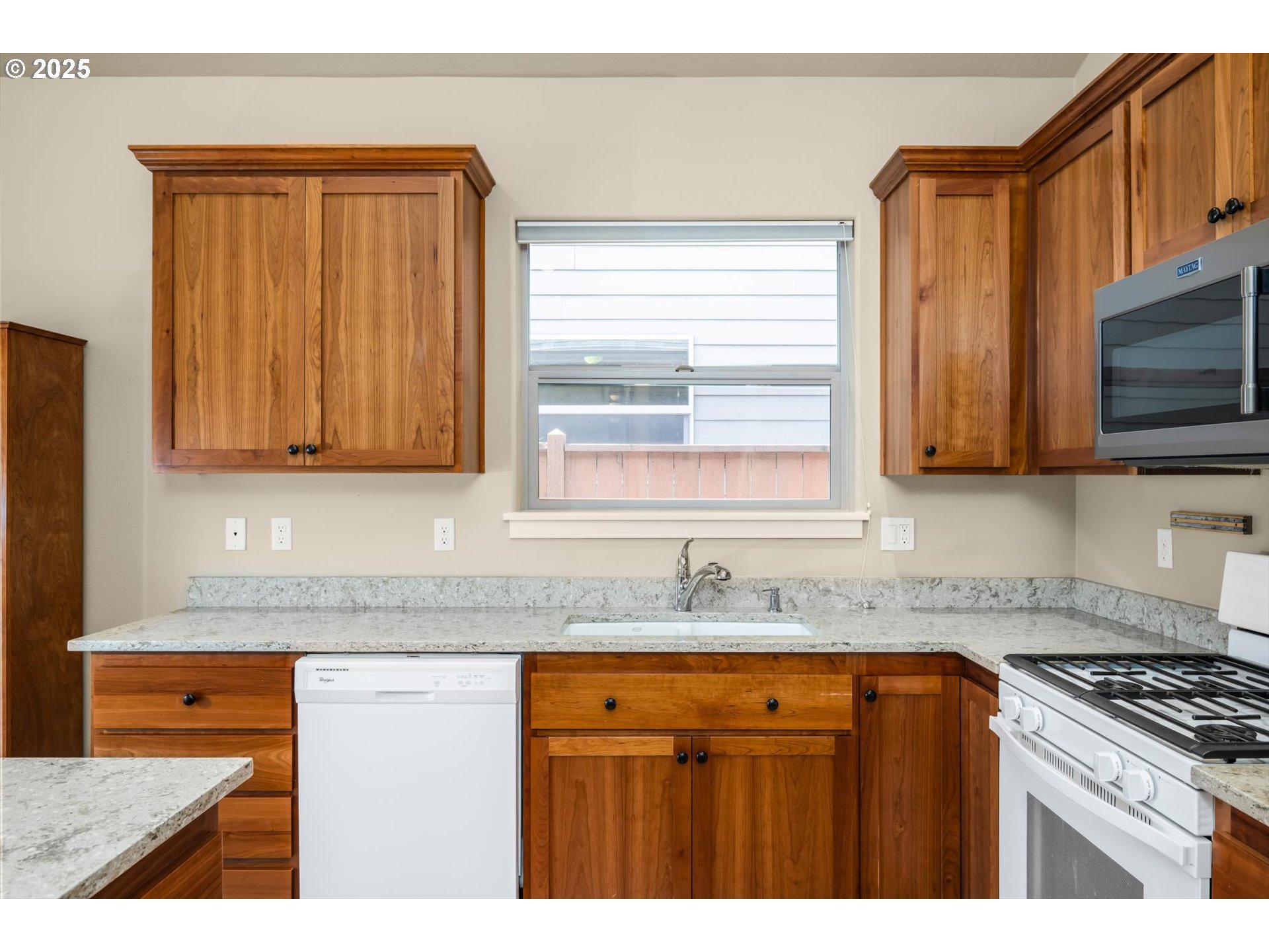 3768 Pachysandra Place Eugene, OR 97402 - Photo 16 of 41 a kitchen with granite countertop stainless steel appliances a stove a sink and a microwave