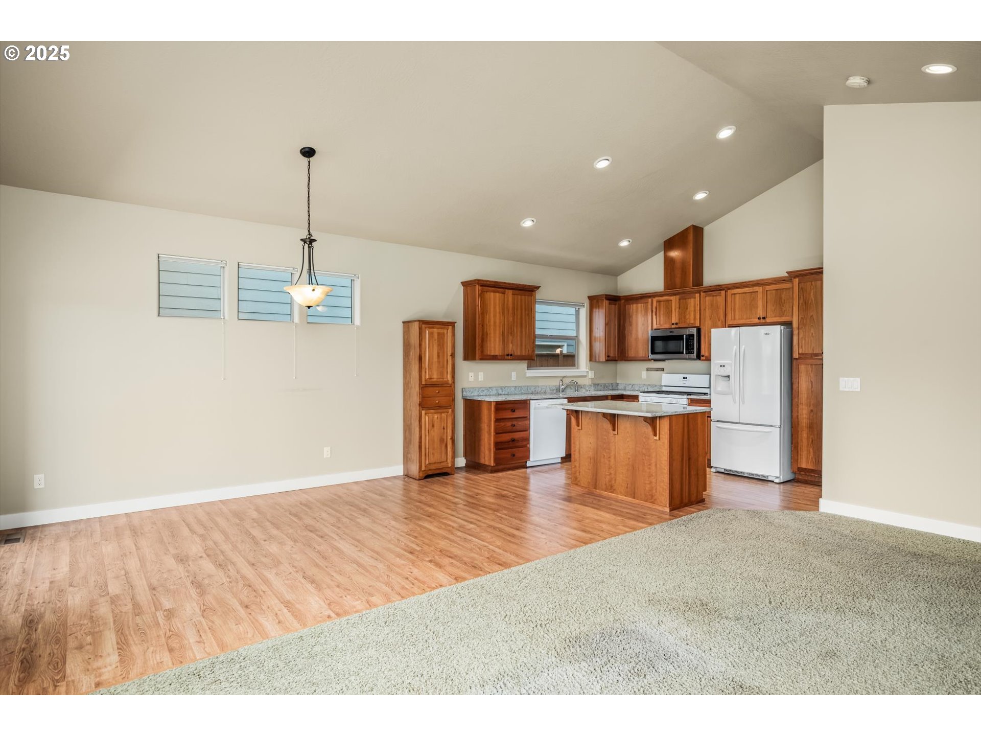3768 Pachysandra Place Eugene, OR 97402 - Photo 9 of 41 a kitchen with stainless steel appliances kitchen island granite countertop a refrigerator and a sink