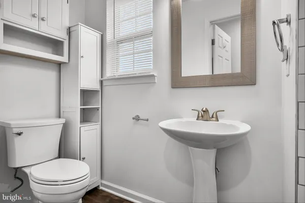 a bathroom with a sink a toilet and mirror