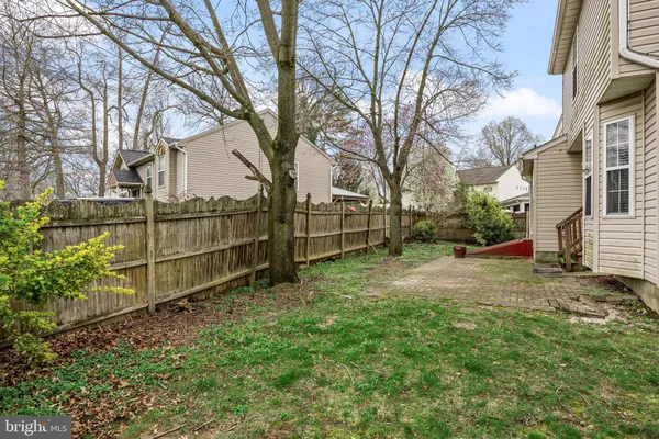 a view of backyard with wooden fence