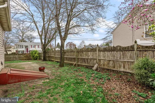 a view of backyard with wooden fence