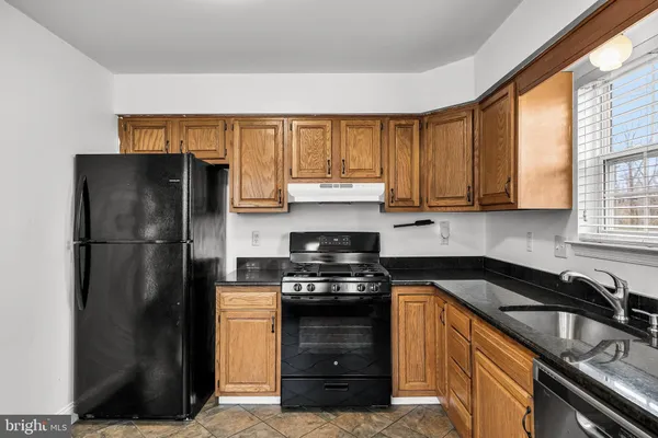 a kitchen with a refrigerator and a sink