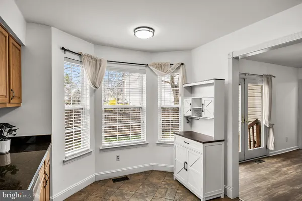 a kitchen with granite countertop a refrigerator and a stove
