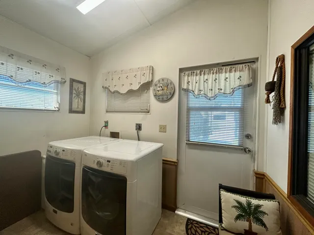 a utility room with cabinets washer and dryer