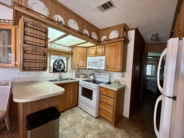 a kitchen with a stove sink and a refrigerator