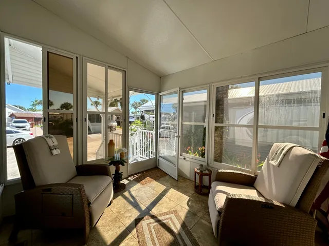 a living room with furniture and floor to ceiling windows