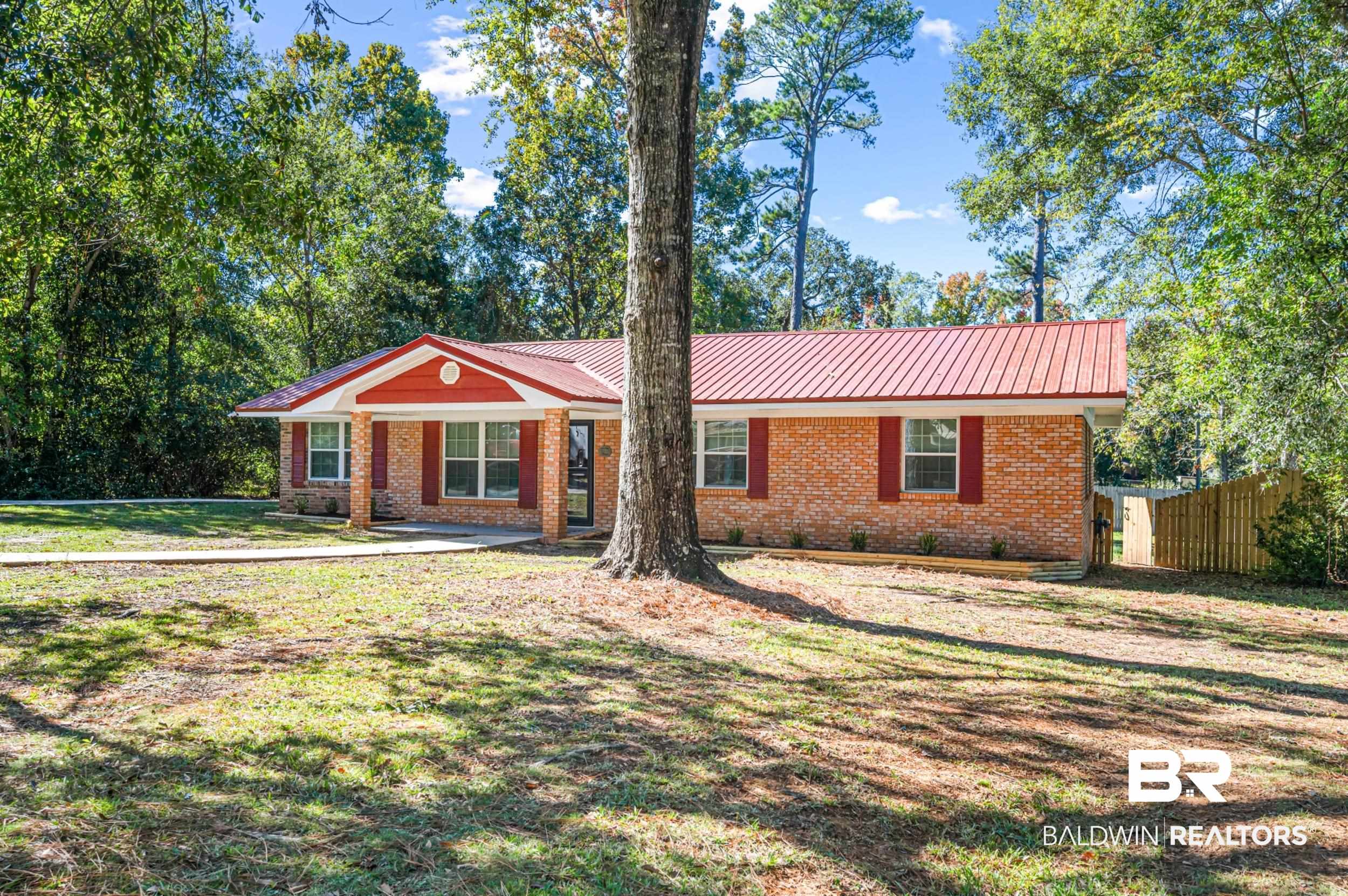 1605 Collier Avenue Bay Minette, AL 36507 - Photo 3 of 36 Ranch-style home featuring brick siding, a metal roof, and covered porch