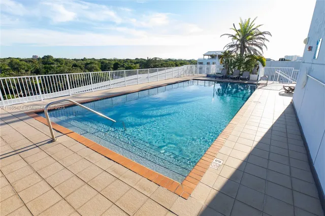 a view of swimming pool with a lounge chair