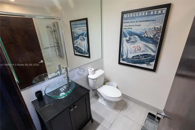 a bathroom with a toilet a sink and mirror