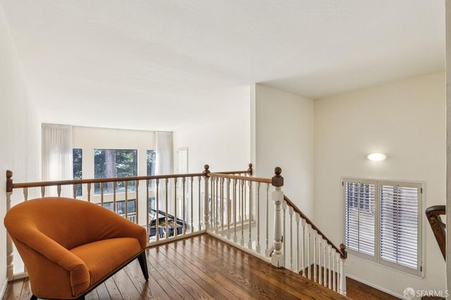 a balcony with furniture and wooden floor