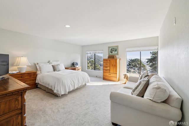 a spacious bedroom with a bed and couch